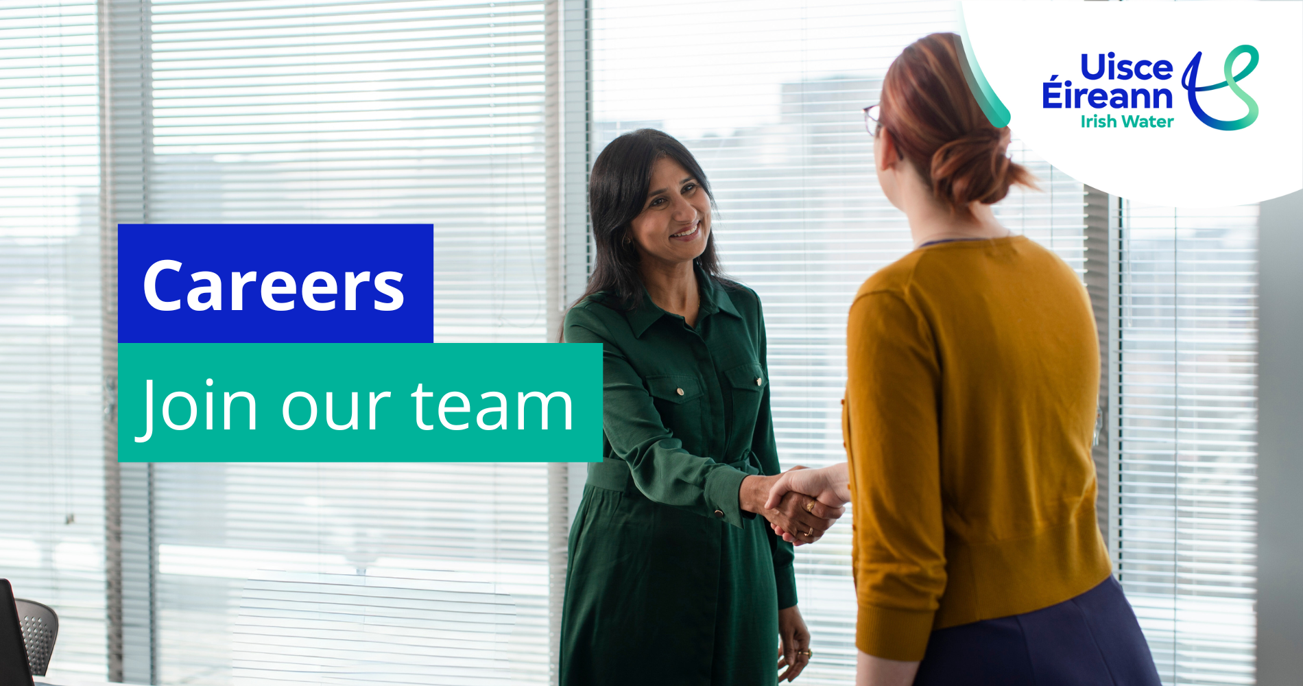 Two office workers shaking hands