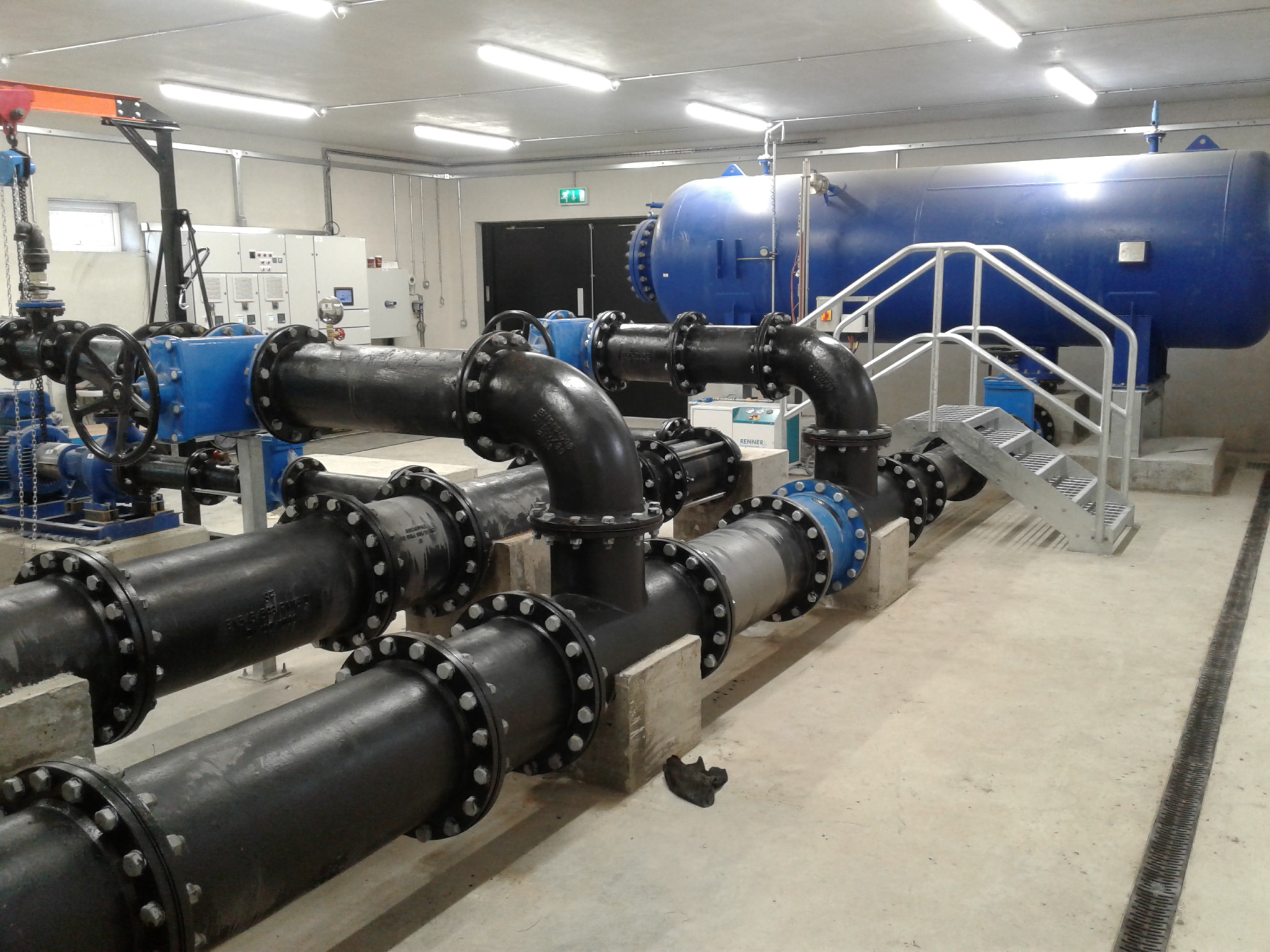 A water tank with large pipes in a room