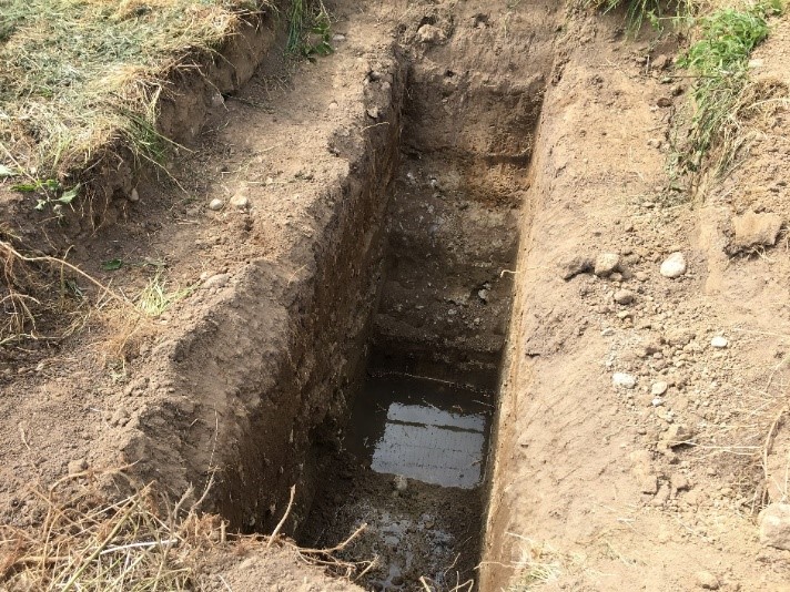 A trial pit dug up on a dry soil