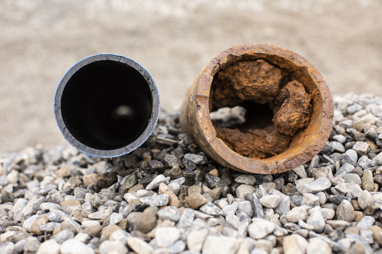 A corroded lead pipe and plastic pipe