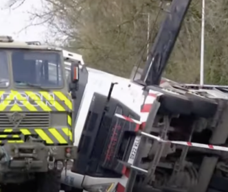 Crane topples thumbnail, a truck with a crane that has fallen on its side