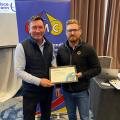 Tom Enright being awarded an award