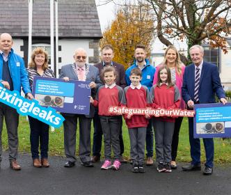 Uisce Éireann shareholders holding up signs with Teachers and Students for Fixing Leaks