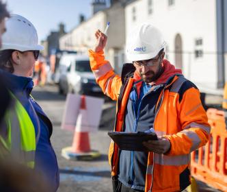 Engineer giving out instructions to the wider team during roadworks