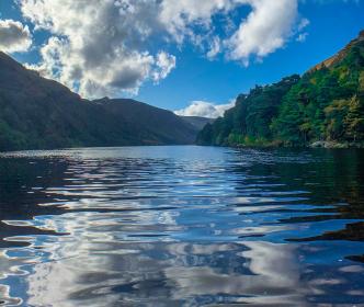 two Uisce Éireann workers talking infront of a digger 