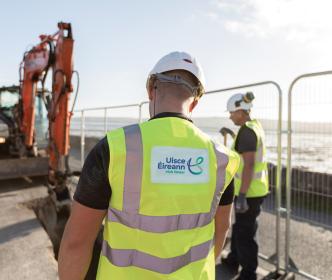 An Uisce Éireann worker looking at a digger removing gravel at Dungarvan Green-way