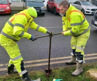 Uisce Éireann workers fixing issues with the water supply on a street
