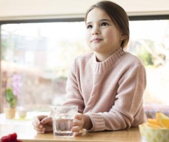 A girl with a glass of water