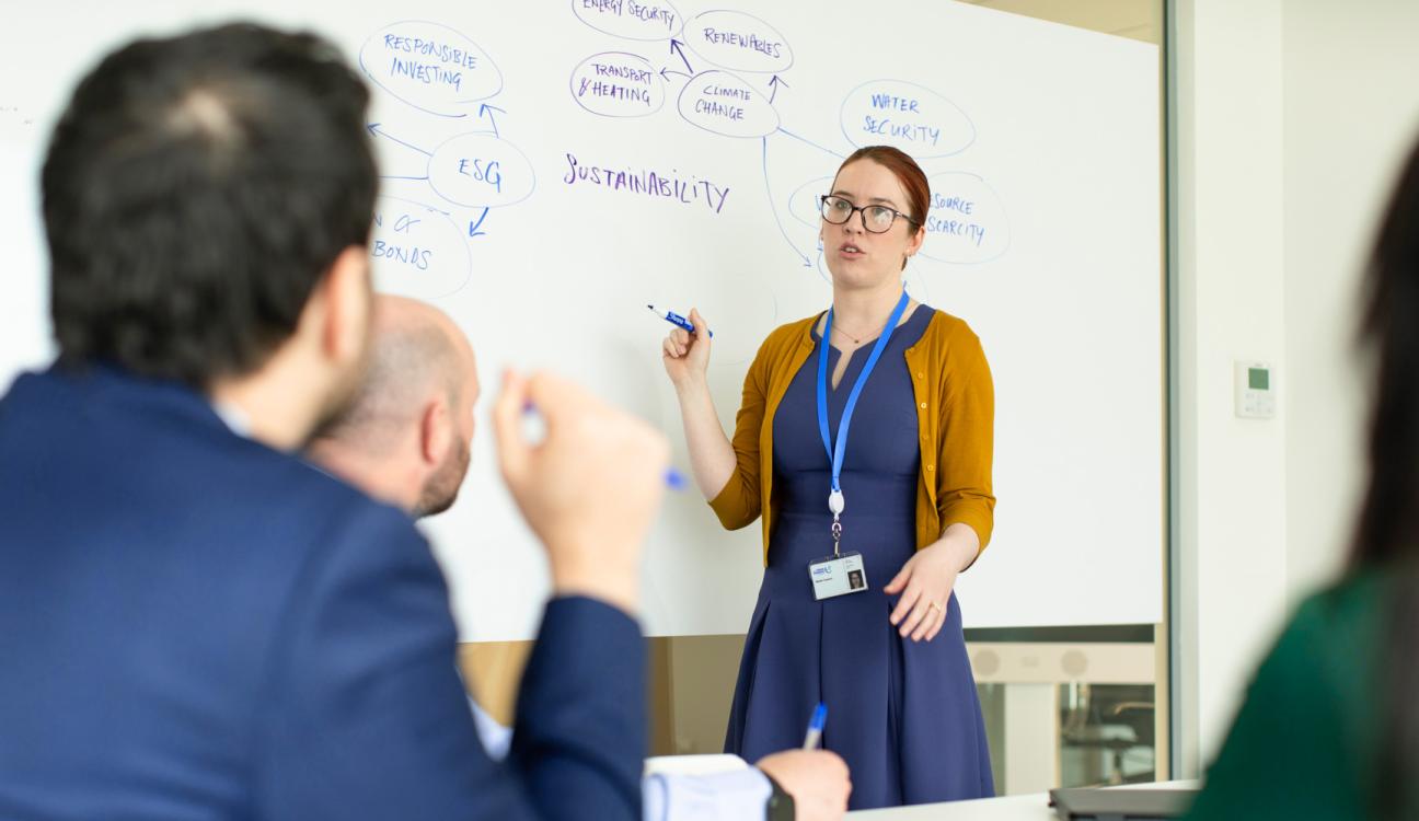 An Uisce Éireann worker giving a presentation on sustainability using a whiteboard